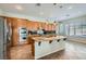 Spacious kitchen with granite countertops, a center island, stainless steel appliances, and ample cabinet space for storage at 313 Glenridding St, Las Vegas, NV 89183