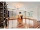 Bright and airy living room featuring hardwood floors, a custom built-in bookcase, and natural light from several windows at 313 Glenridding St, Las Vegas, NV 89183