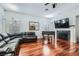 Cozy living room featuring hardwood floors, a fireplace, a large TV, and comfortable seating, perfect for relaxing at 313 Glenridding St, Las Vegas, NV 89183