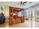 Stunning main bedroom with luxurious canopy bed, hardwood floors, and sliding glass doors to the yard at 313 Glenridding St, Las Vegas, NV 89183