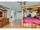 Inviting main bedroom with a four-poster bed, wood floors, and a spacious layout, creating a relaxing retreat at 313 Glenridding St, Las Vegas, NV 89183