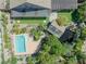 Aerial view showcases sparkling pool, backyard pergola, mature trees, and picturesque pond at 3330 Wedo Way, North Las Vegas, NV 89031