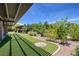 Relaxing backyard with lush lawn, shade structure and well-manicured landscaping creates a private oasis at 3330 Wedo Way, North Las Vegas, NV 89031