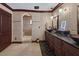 Spacious bathroom featuring dual vanities, walk-in shower, and elegant tile work for a spa-like experience at 3330 Wedo Way, North Las Vegas, NV 89031
