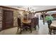 Elegant dining room featuring stone walls, wood beams, and ornate chandelier, creating a rustic ambiance at 3330 Wedo Way, North Las Vegas, NV 89031