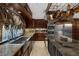 Expansive kitchen featuring stainless steel appliances, granite countertops, and custom hanging pot rack at 3330 Wedo Way, North Las Vegas, NV 89031
