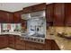 Gourmet kitchen featuring granite countertops, stainless steel appliances, and custom cabinetry at 3330 Wedo Way, North Las Vegas, NV 89031