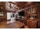 Cozy living room with dark wood paneling, coffered ceilings, and a built-in entertainment center at 3330 Wedo Way, North Las Vegas, NV 89031