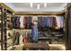 Organized walk-in closet with custom shelving, hanging rods, and ample storage space for clothing and accessories at 3330 Wedo Way, North Las Vegas, NV 89031