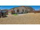 Spacious backyard featuring gravel landscaping, artificial turf accents, and a gated entrance at 3716 W Colton Ave, North Las Vegas, NV 89032
