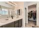 Modern bathroom featuring a double sink vanity, a glass-enclosed shower, and a walk-in closet at 3716 W Colton Ave, North Las Vegas, NV 89032