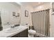 Clean bathroom with a single sink, a toilet, and a shower with a striped shower curtain at 3716 W Colton Ave, North Las Vegas, NV 89032
