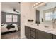 Well-lit bathroom with double sinks and a connecting bedroom with plush carpet at 3716 W Colton Ave, North Las Vegas, NV 89032