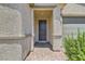 Covered entryway featuring stone columns and a dark front door with a brick paver walkway at 3716 W Colton Ave, North Las Vegas, NV 89032