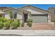 Beautiful desert home with a two-car garage, neutral color scheme, and low maintenance landscaping at 3716 W Colton Ave, North Las Vegas, NV 89032