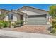 Charming single-story home featuring a two-car garage, desert landscaping, and neutral color palette at 3716 W Colton Ave, North Las Vegas, NV 89032