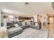 Open-concept living room featuring tile flooring, a large sectional sofa, and easy access to the kitchen at 3716 W Colton Ave, North Las Vegas, NV 89032
