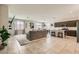 Spacious living room with a large sectional sofa, tile flooring, and open layout connecting to the kitchen at 3716 W Colton Ave, North Las Vegas, NV 89032