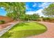 A serene backyard with a manicured putting green and lush landscaping invites relaxation and recreation at 4044 Villeroy Ave, Las Vegas, NV 89141