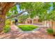 Backyard with putting green, desert landscaping and mature trees, offering a serene outdoor space at 4044 Villeroy Ave, Las Vegas, NV 89141