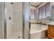 Bathroom featuring a shower, soaking tub, and wood-finish vanity at 4044 Villeroy Ave, Las Vegas, NV 89141
