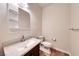 Bright bathroom featuring a speckled granite countertop and convenient floating shelves for added storage at 4044 Villeroy Ave, Las Vegas, NV 89141