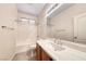 Bathroom featuring tub-shower combination, single sink vanity and large mirror at 4044 Villeroy Ave, Las Vegas, NV 89141