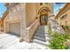 Inviting front entrance with stone steps leading to the front door and a two-car garage at 4044 Villeroy Ave, Las Vegas, NV 89141