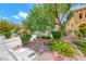 Lush front yard featuring colorful flowers, gravel accents, and mature landscaping at 4044 Villeroy Ave, Las Vegas, NV 89141