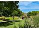 Lush green space with a walking path and mature trees offers a tranquil environment for outdoor activities at 4044 Villeroy Ave, Las Vegas, NV 89141