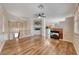 Bright living room featuring hardwood floors, a fireplace, and an open staircase at 4044 Villeroy Ave, Las Vegas, NV 89141