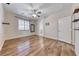 Bright main bedroom with wooden floors, ceiling fan, and shelving at 4044 Villeroy Ave, Las Vegas, NV 89141