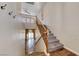 Carpeted staircase with wooden banister leading to an open-concept living area at 4044 Villeroy Ave, Las Vegas, NV 89141