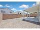 Spacious backyard featuring desert landscaping, a covered patio, and secure block wall fencing at 4132 Joyous St, North Las Vegas, NV 89032