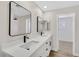 Bright bathroom featuring a double sink vanity, modern mirrors, and sleek, black hardware at 4132 Joyous St, North Las Vegas, NV 89032