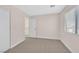 Neutral-colored bedroom with a window, carpet flooring and lots of natural light at 4132 Joyous St, North Las Vegas, NV 89032