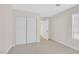 Bright bedroom features neutral tones, plush carpet, a window, and a spacious closet for storage at 4132 Joyous St, North Las Vegas, NV 89032