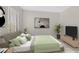 This staged bedroom showcases a cozy bed with stylish decor and a serene ambiance at 4132 Joyous St, North Las Vegas, NV 89032