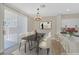 Stylish dining area next to the kitchen features a modern light fixture, a table, and ample seating at 4132 Joyous St, North Las Vegas, NV 89032