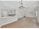 Open-concept area featuring a contemporary kitchen and a dining area with bright, natural light at 4132 Joyous St, North Las Vegas, NV 89032