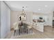 Contemporary dining area featuring a modern chandelier, stylish table setting, and a kitchen island at 4132 Joyous St, North Las Vegas, NV 89032