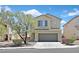 Charming two-story home featuring a two-car garage, manicured landscaping, and beautiful desert surroundings at 4132 Joyous St, North Las Vegas, NV 89032