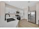 Modern kitchen with stainless steel appliances, white cabinets, and sleek countertops at 4132 Joyous St, North Las Vegas, NV 89032