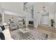 Spacious open-concept area featuring a living room, staircase, dining area, and a modern kitchen at 4132 Joyous St, North Las Vegas, NV 89032