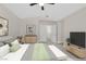 Staged primary bedroom features a ceiling fan, soft carpet, neutral walls, and closet access at 4132 Joyous St, North Las Vegas, NV 89032
