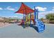 Community playground featuring a colorful play structure with slides, stairs, and a shaded picnic area at 4132 Joyous St, North Las Vegas, NV 89032