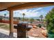 Covered patio with a built-in grill, offering views of the surrounding desert landscaping at 414 Crystal Canyon Dr, Mesquite, NV 89027