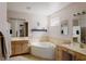 Bright bathroom with a soaking tub, dual vanities, and neutral tile, offering a spa-like experience at 414 Crystal Canyon Dr, Mesquite, NV 89027