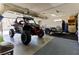 Spacious garage showcasing a black off road vehicle and trailer, ideal for adventure enthusiasts at 414 Crystal Canyon Dr, Mesquite, NV 89027
