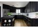 Modern kitchen with black cabinets, stainless steel appliances, and an island with seating, offers a stylish and functional space at 414 Crystal Canyon Dr, Mesquite, NV 89027